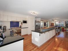  21 Zanzibar Loop, Aveley WA 6069 The kitchen is every chefs dream with transformation granite bench tops, double sink, stainless steel appliances including rangehood, 900mm cooker,dishwasher recess, big utility cabinet, microwave recess, overhead cupboards and an abundance of cupboards, pot drawers and benchtoips perfect for the master chef. This area is centrally located so it looks over the dining and family room. The dining area is very spacious and will accommodate a 10 – 12 seater dining table perfect for family and friends. A beautiful built in bar in the family area is perfect for entertaining with its own sink and perfect to sit up and relax or walk through sliding doors out to the alfresco area under the main roof. French doors separate the family area from the Theatre room which is very large and has r/c a/c. The main bedroom is huge with a large walk in robe and ensuite with double vanity, big shower, heater lamp, tiled to the ceiling and toilet. Laundry has built in cupboards and separate powder room. Walk up the stairs to a very large family area with marri flooring, rake ceilings, and sliding doors out to the balcony area. Bedrooms 2,3 are double in size and have built in 3 door robes. Bedroom 4 & 5 also are double in size double door robes and sliding doors out to the balcony with views to the reserve and beyond.. 3 Car garage. A Huge powered workshop at the back with access through from the garage. Shade sails, fully reticulated gardens, Storage under stairs, ducted air conditioning upstairs. Viewing this lovely home is a must call Donna to view. 