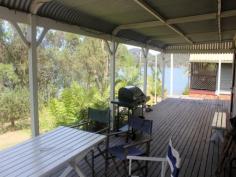  40 Kalinda Road Bar Point NSW 2083 In perfect condition, this two bedroom cottage on a beautiful waterfront reserve is close to the pontoon shared with 2 other neighbours. This house has been used as a weekender for the family for many years, and is very well-maintained. The kitchen and bathroom are excellent, and the large comfortable living room, with slow combustion fireplace, opens to a generous covered verandah right across the front overlooking the reserve and Hawkesbury River. There is plenty of cleared space around the house, with a garden shed at the back. Nothing to spend – move in right away. This home has a welcoming feeling when you walk in, and lends itself to family living and entertaining. 
