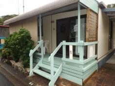  N4 White Albatross Nambucca Heads NSW 2448 Entry to this home is via a glass sliding door from a private front verandah, located in the White Albatross Over 50's Park at the entrance of the beautiful Nambucca River. A fresh feel to the lounge room on entry has glass mirrored tiles giving length to the room. The lounge and dining with new carpet underfoot flows through to the kitchen, with the added comfort of air conditioning. The kitchen with new timber look a like vinyl flooring, comprises of electric upright cooker and range hood. Adjacent to the lounge is the 2nd bedroom with glass sliding doors to a back verandah. This room also has direct access to the bathroom as does the main bedroom. Leading from the dining room, with new carpet and mirrored built in robes is the main bedroom. The bathroom come laundry, has a toilet, vanity, shower and linen cupboard. There is convenient room for a washing machine within this area. Externally the property has a single carport, with paving to the rear. A covered back verandah has shade cloth blinds and a great area to hang washing on a rainy day. Step down to a delightfully maintained lawn area with bush further a field, this outlook is definitely a feature of the property.  