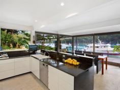  18-20 Sturdee Lane Lovett Bay NSW 2105 Laffing Waters ONLY TRUE NORTH facing waterfront Pittwater property on two titles with facility for 70' + boat. A waterfront property over 29 meters with sandy beach and features; Built over waters edge to the highest standard with amazing 180 degree views of Pittwater to Palm Beach, with sun all day in winter, and the north easterly sea breeze in summer. An amazing home that must be seen to be appreciated. * Ground floor features a modern kitchen, granite bench tops, Miele appliances and abundance of cupboard space. The open plan dining and lounge have sliding floor to ceiling windows open out onto a large cantilevered balcony over the water, plus a designer wood burning fire place. * Master bedroom with ensuite and spa, built-in robes, sitting room and adjoining study all with brilliant water views, a further two bedrooms and ensuite also with water views. * Self contained king size cabin with ensuite, surrounded by landscaped gardens, a separate alfresco dining pavilion with Danish wood burning fireplace. * Reverse cycle ducted / zoned air conditioning, town water, auto sprinkler system. General Features Property Type: House Bedrooms: 4 Bathrooms: 3 Indoor Features Ensuite: 1 Study Other Features Fireplace, Jetty, Storage, Waterfront, Waterview 