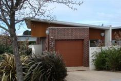  3a Berkshire Parade Penguin Tas 7316 $285,000 Property Information This stunningly beautiful, architecturally designed unit is only 4 years old and a must see! The open plan living area boasts beautifully polished timber floors & a reverse cycle heat pump whilst the kitchen has been superbly designed and fitted with Bosch stainless steel appliances including dishwasher, under bench oven, ceramic bench plates, range hood, and double sink. The 2 double bedrooms both have large built-in robes, TV and phone sockets & glass doors leading out to the rear garden.  An alfresco dining area is easily accessible by opening the fold back doors in the living room, adding yet another dimension to living in this superb unit.  Putting the car away has been made so easy by the instillation of a remote control roller door to the large single garage which also features internal access to the unit.  With a land size of approximately 416m2 the low maintenance landscaped gardens will leave you with plenty of time to sit back relax and enjoy the best of modern living. If you wish to know more about this unit I please call Andrea Bishop in the Harcourts Penguin office or phone 0427 346 817 Property condition 	 Excellent Property Type 	 Unit House style 	 Contemporary Garaging / carparking 	 Single lock-up Construction 	 Brick veneer Joinery 	 Aluminium Roof 	 Colour bond Walls / Interior 	 Gyprock Flooring 	 Carpet and Timber Window coverings 	 Drapes Heating / Cooling 	 Reverse cycle a/c Chattels remaining 	 Drapes, Fixed floor coverings, Light fittings, Stove, TV aerial Kitchen 	 Modern, Open plan, Dishwasher, Separate cooktop, Separate oven, Rangehood, Double sink and Breakfast bar Living area 	 Open plan Main bedroom 	 Double and Built-in-robe Bedroom 2 	 Double and Built-in / wardrobe Main bathroom 	 Bath, Separate shower Laundry 	 Separate Views 	 Urban Outdoor living 	 Entertainment area (Uncovered) Fencing 	 Partial Land contour 	 Flat to sloping Grounds 	 Landscaped / designer Water heating 	 Electric Water supply 	 Town supply Sewerage 	 Mains Locality 	 Close to schools, Close to transport Fixtures/chattels excluded 	 1 x heat pump 1 x Bosch dishwasher 1 x Bosch Under bench Oven 1 x Bosch Range hood 1 x Bosch Ceramic hotplates 