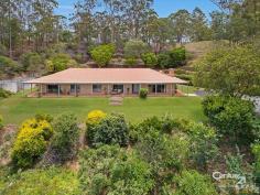  25 Trossachs Pl Upper Kedron QLD 4055 ACREAGE HOME WITH VIEWS TO MORETON BAY Delivering the charm and tranquility of a country lifestyle on a private 4ha approx.) block with the convenience city living provides, the decision to embrace that idyllic tree-scape you desire has just been made easier with this family residence.  With nature knocking at your door, local birdlife constantly singing their calming melodies, wallabies grazing on the lawn and scenic views all around, it's fair to say the everyday stresses simply melt away the moment you arrive home. The benefits of multiple living areas coupled with four bedrooms mean there's a place for every member of the household.  A simple design featuring 9ft ceilings and the vast collection of large windows promote maximum daylight use, allowing the home to be bathed in natural light and decorated with magnificent leafy views. A large kitchen also adds appeal to the contemporary communal living space, delighting with its sheer size.  The formal lounge and dining offers the perfect space to enjoy movie nights with the kids; it also features Tasmanian Oak bookcases and cabinet. Other considerations are  - 1440m2 (approx) house pad, barn  - 9 metre in ground salt water pool  - Air conditioning to master suite  - 2 x 22,700 litre concrete tanks  - Less than 5km to Ferny Grove rail (or 4 minutes' by car)  - Cypress pine wall framing and trusses  - Close to state and private schools  - 12M x 7M American style barn and garage  - The barn also has a 56 square meter mezzanine level area accessed by an internal staircase  - Bitumen Driveway and parking area  - 4 car garage accommodation  - Views over the city lights and to Moreton Bay  Morning strolls or a weekend bike ride through the leafy hills will become a favourite pastime, and enjoy the convenience of living within moments of Ferny Grove Shopping Village, train and bus transportation at the Ferny Grove Station, well-regarded schools and only 18km from the Brisbane City Centre. With homes such as these a rarity and the suburban urban block getting smaller and smaller this is an opportunity not to be missed  PROPERTY DETAILS UNDER CONTRACT ID: 390730 Land Area: 40000 m² Zoning: Large Housesite 