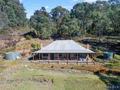  30 Gaffneys Creek Track Gaffneys Creek VIC 3723 $359,000 A remarkable re-creation of the original Gaffneys Creek homestead “Clay Banks” providing an outstanding snapshot of a bygone gold mining era. Completely rebuilt in 2009 with a craftsman eye for quality and detail, the result is a character laden home of immense charm plus outside storage room of similar style. High ceilings throughout, excellent kitchen and dining area, separate lounge opening onto front verandah and 4 double bedrooms on 1888m2 of land. Home rebuilt around original fire places, great water supply and terraced stone retaining walls all contribute to the character. With stunning, tranquil views overlooking the Raspberry Creek valley and capturing the early morning sun. A sensational setting for a unique property. Inspection by appointment. Features  Balcony  Water Tank 