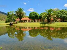  2448 Beaudesert Nerang Road Canungra QLD 4275 $1,775,000 2 Luxury homes situated on over 10 acres with approx 270m creek frontage!  This is one of those properties that many people dream of and it could be yours...  The acreage is fully usable, fertile and private with unlimited water supply from the creek and bore to service any of your hobbies you wish to pursue.  Main residence, tastefully renovated:  * 3 spacious bedrooms with an ensuite, including spa, off the master bedroom which opens up to the outdoor area.  * Spacious kitchen overlooking the large open plan living and dining area with crisp/fresh decor opening up to the welcoming in ground pool.  * Ducted air conditioning to cool and heat the home and a combustion heater and fans throughout.  * Main bathroom located across from the 2 bedrooms with separate toilet, as well as a study large enough to be a 4th bedroom.  * Double garage with remote controlled doors.  The Cellar house:  This is something spectacular, particularly for those that love to entertain. It is also overlooking the stunning pool and a recently built gazebo.  It boasts a massive open plan area with teppanyaki kitchen that is an ideal area to have a game of billiards. It features a cosy open fire, ducted heating and cooling and separate bathroom, oh and to add to the sense of luxury there is also a sauna!  Complete with another living and dining area, kitchen and a bedroom that would suit a king complete with ensuite and walk in robe, this is a beautiful home all on it's own.  This is perfect for the extended family, young, old, or perhaps an extra income for holiday letting, being so close to town and all the activities the Scenic Rim has to offer.  Internal stairs take you down to the enormous wine cellar, with walls lined with wine racks to hold your special collection and is complete with another kitchen. It's the perfect place to entertain with a difference. It has the feel of a high class restaurant at a vineyard.  Outdoors: 12 x 6 m shed with power, awning and large avairy that could be converted to stables and separate paddock with equine fencing.  Outlets around the property to supply water for irrigation to the established gardens, lawn/paddock and impressive palm trees.  Picturesque dam full of turtles and an ideal area to sit back and take in nature and the stunning surrounding views. Or sit by the creek and enjoy the flowing water at your feet. The opportunities for this property are endless, particularly for our growing community and tourism.  Only minutes to local cafes and speciality shops which thrive on the weekends. This property is certainly one that you must inspect to appreciate all it has to offer. 