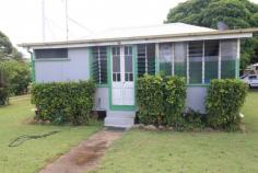  127 Wilmington St Ayr QLD 4807 $79,000 Don't miss this idea opportunity as this low set 1 bedder is perfect for those starting out in the market or looking for that good sized block to build or as a 'rental' which is it's current use and recieving $165 per week... WOW... Priced to please and on a fenced 1012m2 lush town block bragging only minutes away from the CBD, supermarkets and schools... Offering combined kitchen and dining with good sized living area and  one bedroom which is air conditioned... Front enclosed verandah which is also home to the bathroom amenities... Downstairs under the back lean to is the laundry... The yard is fenced and with a handy garden shed and dotted with fruit trees including mango, citrus and passionfruit. Bragging a tremendous amount of room for that colour bond shed and so much more... This one won't last long so hurry and call to arrange your inspection today! FEATURES Verandah Undercover outdoor area Fenced Close to school 