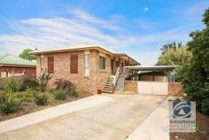  9 Peacock Avenue West Wodonga VIC 3690 $399,000 In one of West Wodonga's most admired locations and offering the most convenient of lifestyles, is this impressive family home. Built with the growing family in mind, this large double storey residence combines the space, comfort and style so often sought yet seldom found. With living spread across both levels, the home comprises of five bedrooms plus a study all featuring built-in storage and ceiling fans, the master is finished with a walk-in robe and convenient ensuite. Upon entering the home, you are greeted by the naturally flowing floor plan with thoughtfully designed kitchen area and dining room adjacent. The kitchen features plenty of storage options, gas cooking and incorporates views from the elevated position. The large lounge room is a real family area, the perfect space for family movie nights. Downstairs lies two bedrooms sharing access to a second living area presenting as an ideal teenage retreat. Enjoy entertaining all year round with the rear balcony offering 180 degree views and ample space for a BBQ and outdoor dining table. Further entertaining space is available downstairs with access to the low maintenance rear yard which the kids are sure to enjoy. A large double garage with additional carport space, enough room for a further four cars ensure the family vehicles are secure no matter how big the family is. Other additional features include ducted heating and evaporative cooling plus fantastic storage under the house. Positioned in an enviable location this property is sure to tick all of your boxes and provides enough room for the entire family. Call today! 