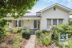  2 Tower Street Wodonga VIC 3690 Located only minutes away from the fast-developing CBD lies this family home filled with character and charm. Upon entering through the established front garden, you are greeted by the gorgeous weatherboard home creating a private oasis sure to leave you in awe. Ornate cornices, ceiling roses and chandelier light fittings encompass the stunning period features that bring this home to life. Comprising of three generous bedrooms, two of which include built in storage. The family bathroom is conveniently located central to the bedrooms and features a deep bath, single vanity and toilet. An additional shower and toilet can be found in the laundry providing added flexibility for the growing family. With a naturally flowing floorplan, the spacious front lounge transitions through to the formal dining room with sunroom adjacent. The kitchen is where style meets character, comprising of an impressive curved bench with electric appliances and spacious walk in pantry. Ducted heating & evaporative cooling provide comfort all year. Outside the undercover entertaining area, perfect for year-round gatherings overlooks the low maintenance rear yard. With established plants lining the fence your family can enjoy a picturesque setting. The single garage accessed from a secure driveway will keep the family vehicle safe and provide enough space for a workbench and all the tools to be stored. Only a stones throw away from the centre of town your weekends and date nights will never be the same. Call today to secure your very own private central sanctuary! 