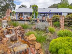  91 Denny Road Nannup WA 6275 $645,000 If you love character in a home then there is no doubt you will fall wildly in love with this one! A decade of work results in a spectacular creation from the unusual gate, the wysteria trellis, the rocky waterfall, the rusty bits of iron in the garden and timbers from both the Busselton and Bunbury jetties in the house. Sitting on a lovely 6.6 acres with Blackwood National Park to the front and the Blackwood River at the back this three bedroom, two bathroom home with its brick hearth and huge jetty beams breathes character from every pore! The mostly native gardens are easy to keep and stunningly attractive. The large back deck looks onto a waterfall with a pond at the base and views of the distant hills. Large shed, fenced orchard and vegie garden, not to mention a fox proof chook pen plus a second smaller waterfall complete the picture. Large dam at the bottom of the block supplies water for the garden and waterfalls with power in 3 places plus gorgeous riverfront views down at the bottom of the block. This has to be seen to be appreciated. 