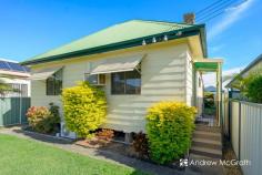  9 Galgabba Street Swansea NSW 2281 $550,000-$595,000 A gorgeous classic cottage on a flat block in the much sought-after Swansea North. Get in touch soon because this one won't be available for long! REAR LANE ACCESS via Neale Ln to a spacious double-doored garage; immaculate easy-care gardens complimented by two covered, multi-purpose al fresco areas; a great foundation with shedloads of potential!? This is as perfect a first home as it would be forever home or investment project! Guests are welcomed by a well-kept front lawn and enter, via the fenced yard, through the covered, elevated porch to the spacious living room with polished timber floor boards. TV point and air conditioning make sure you'll always find comfort in here all year round. Through to the classic central kitchen complete with a double stainless steel sink, solid timber bench tops and built-in cupboards and laminate cabinetry. Thanks to the space, ample bench tops and simple layout, every culinary experience here a pleasure, whether you're cooking up a storm or just making a cuppa. To the rear of the home, the dining room, which has the space to be as versatile as you'd need it to be, offers views of and access to the backyard. Ideal for catch-ups with friends and lazy weekends. Step from here into the backyard's two adjacent covered entertaining areas or beyond into the bright and and you'll know this is the home for you! Bedrooms both enjoy ample sunlight through good-sized windows, with bedroom 1 sporting a large upright wardrobe, and both are close to the bright, well-appointed and very practical bathroom. All practicalities aside, this home's location is itself the ultimate added extra. It provides quick and easy access to every leisure whim and necessity available in the area. Just minutes from Swansea's main street shops, a short walk from Chapman Oval, Swansea skate park, and the beautiful Swansea Channel foreshore, and barely a five minute drive from the pristine and patrolled shores and waters of Blacksmiths and Caves Beaches. Get in touch with Bec or Andrew on (02) 4972 1066 to find out more! KEY FEATURES: Close to Schools Close to Shops Close to Transport Garden Separate Dining.. 