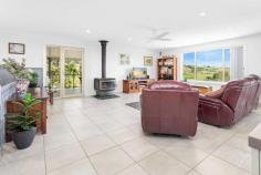  2a David Smith Place Kiama Heights NSW 2533 $1,960,000 - $2,150,000 Situated on almost one acre of land with a private aspect from surrounding properties and enjoying ocean and rural views, this large home invites a prestigious way of living in the beloved coastal town of Kiama. Before entering the property, the outdoor features of this residence are a staple in itself. With first impressions of this large lot residential property influenced by a gated driveway, highly maintained lawns, and a feature water fountain, the home presents unlike many others with a sense of premium exclusivity. Park your caravan under the freestanding shelter, park multiple cars in the port cochere, two-car garage or under the carport. With well-established veggie patches, flourishing gardens, and a well-looked-after swingset, there is plenty to keep kids and adults entertained. Upon entering the property you are greeted with elevated 9ft ceilings and polished tile flooring. The home comprises five bedrooms with the master suite hosting a walk-in wardrobe and modernised ensuite, another two bathrooms, a dining area that flows into the oversized living room, a kitchen with modern appliances and Caesarstone benchtops, and the entertainers dream with a large verandah, perfect for hosting friends and family. Downstairs you will find the tinkerers retreat, complete with a large workshop, two-car garage and bathroom. Offering multiple areas to either work from home, host friends and family, lounge in the oversized family room or outdoor space, or enjoy family picnics in the yard, this home truly caters to your needs. This home is sure to entice those who are looking for that perfect family home, investment or holiday home. 