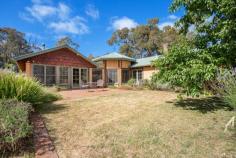  36 Kirby Road Armidale NSW 2350 'Murrungundy' is not just a house, but the delightful coming together of a unique home and a New England bushland setting. Created from the very earth it sits on, each mud brick was handcrafted on site, then laid as an infill between the exposed hardwood timber frame. Locally reclaimed railway timbers add to the rustic charm of this truly captivating home. The main dwelling utilises a 3-bedroom layout. The master benefits from a northerly aspect, walk-in robe and en-suite and provides excellent privacy being located at the opposite end of the house to the other bedrooms. These two bedrooms both offer built-ins and are large enough to accommodate a queen bed with ease. A formal sitting room with open fire and a mix of reclaimed and custom fit windows and doors, leads into the central octagonal dining area. The north facing living room captures the warmth from the sun in the winter months, thanks to the full-length glass in the windows and doors. Warmth is retained by the slate tile floor which acts as a heat bank. Slow combustion wood heating assists on the coolest of days, and a heat transfer circulates warmth down to the south-eastern bedrooms. Stunning cathedral ceilings with locally milled blue gum timbers feature throughout. The custom timber kitchen flows onto both the dining and living areas, creating the perfect space to entertain. Gas cooktop with the option of gas or electric oven, ample cupboard space and beautiful views across the valley enhance the features of this space. A fully self-contained granny flat adjacent to the house provides excellent versatility for visitors, guests or as a teenager's retreat. The accompanying 40 acres of semi-cleared and undulating bushland, with excellent water supplies, provides enough room for a few head of cattle or horses, or to simply enjoy the local wildlife that pass by daily. Enjoying a picturesque rural aspect only minutes from both the University of New England and the town of Armidale adds to the attractiveness of this property. 