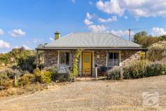  2 Illogan Street Burra SA 5417 $335,000 - $345,000 Located in the Historic mining town of Burra, Nestled between the lush Clare Valley and the red dirt of the Outback, Melissa & Robert are thrilled to Introduce this charming Stone Cottage, a piece of history nestled on a corner allotment spanning 509 square metres in picturesque Australia. This quaint abode, built in 1860, exudes character and warmth. As you step inside, your feet will meet the inviting floorboards that grace the lounge and entryway. A ceiling fan gently stirs the air, ensuring comfort year-round. The master bedroom is adorned with carpeting, creating a cozy retreat. A newly renovated kitchen boasts modernity, featuring elegant tiles, an electric oven, and cooktop. Adjacent, an English-style laundry adds a touch of vintage charm. A split system ensures climate control throughout. Additional rooms offer versatility; consider transforming this haven into a 3-bedroom sanctuary or design a study and formal dining area. The possibilities are boundless. The newly renovated bathroom exemplifies luxury and convenience. Escape the urban frenzy and embrace the tranquillity of a tree change. Stone Cottage beckons you to begin a new chapter, enveloped by stunning views that inspire serenity. Alternatively, seize the opportunity to generate income by continuing its successful tenure as an Airbnb. The current owners have relished their role as hosts, with the nearby wind farm enhancing the allure for guests. Seize the chance to own a piece of history, where old-world charm meets contemporary comfort. Stone Cottage is a testament to enduring beauty and endless potential. 