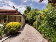 27 Onkaparinga Valley Road, Balhannah, SA 5242 This is truly a rare opportunity to acquire this gorgeous rambling sandstone home with a classic return verandah; surrounded by beautiful grounds containing mature trees and rose bushes. Built in 1860 and extended in 1875, this is a home built by hand and built to last the test of time; it has its own rich history and invites you to create your own memories here. The home has access and right of way to The Onkaparinga River, and the elusive but succulent yabbies found in it. Set back from the road behind a classic picket fence this home offers beautiful high ceilings and large sized rooms and a grand ballroom sized living room / dance studio or use it as a living dining area; the possibilities are indeed many. Escape from city life and unwind as you leave peak hour traffic well behind, welcome to rural living and roaming through the world class wineries and exploring the antique dealers and boutique businesses dotted throughout the fabulous Adelaide Hills. Be spoilt for choice with great pubs, great restaurants and indeed a fantastic country lifestyle here in the heart of the hills. All of this and only 20 minutes to the city via the freeway. This is a home that invites you to spread out and relax, with plenty of room to accommodate a family or even an extended family with the fully self-contained cottage at the back of the block offering an income generating asset or a home for extra family members or B&B (S.T.C.C). The cottage has an open plan kitchenette/ living,bedroom, bathroom & toilet; it has approximately 10,000 litres of rain water plumbed in as well. The keen gardener is going to love the generous sized allotment and opportunity to enhance the grounds as they are or further create new plantings. Step inside the front door and you are greeted by a magnificent hall that leads from the front of the home to the back, graced by ornate columns and plasterwork of a bygone era. Just off of the hall you will find one of the largest rooms I’ve seen in a while, bathed in natural light this room looks out through French doors into the garden with a fish pond. This is a room that simply we call the ballroom; you could use it as a home theatre or combined formal dining & living room. With 4 good sized bedrooms, 3 with original fireplaces; there are also 2 bathrooms and a separate laundry as well. Step into the huge open plan rear living room with a cosy Nectre combustion heater; this room also has its own island bench / wet bar making this a home for the growing family. For the work from home professional there is an office or study that gives you the space and flexibility you need. The country style kitchen is at the heart of the home and it has access to the hallway and to the large formal dining / living room. There is bottled gas connected and the gas hws services the rear bathroom and kitchen. The home also has a double garage down the gravel drive to the rear of the block and a powered shed for the blokes with enough room to keep the tinkerer or restorer happy.