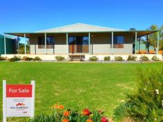  28 NORTH WEST ROAD Badgingarra WA 6521 Take a more simple approach to life and live a relaxed laid back lifestyle away from the hustle and bustle of the city. This lovely modern 3x2 home offers just over one acre of low maintenance living in a quiet community that is just two hours from Perth and also two hours from Geraldton.  This home offers:- • 	 A lovely modern feel with two large living areas • 	 Open plan living area with a recessed ceiling and down lights • 	 Spacious lounge room • 	 Fantastic kitchen with corner pantry, gas stove and room for a large fridge • 	 Three large bedrooms with the master bedroom having a walk in robe as well as large built in robe and an ensuite • 	 Family bathroom has a shower and a separate bath • 	 Reverse cycle split system air conditioner to keep you comfortable all year round • 	 A dream Colourbond steel framed workshop/man cave that is 9m x 12m. It features two electric roller doors, one manual roller door, single and three phase power, a toilet, sink and an enclosed outdoor shower with a gas hot water system • 	 Eight year old steel framed home that has a lovely wide verandah that wraps around it • 	 Solar hot water system, connected to scheme water and also 2 x 32,000 litre rain water tanks that are both full • 	 Well established lawn and gardens featuring a large ornamental fish pond, large enclosed irrigated vegie patch, fruit trees, plenty of wildflowers and a chook yard Badgingarra offers a primary school, post office, mechanics, hardware store, roadhouse/petrol station, tavern/restaurant, recreation centre with tennis courts and bowling green, fire brigade, a large town oval and the golf course which is across the road from this property. Its located just 60 kilometres from Jurien Bay which offers some of the best beaches in WA and also 60 kilometres from Moora. Take a drive today and experience this delightful property for yourself.  