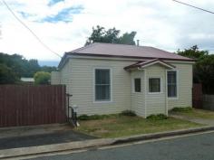  5 Bonney Street Deloraine TAS 7304 2 bedroom home with optional third bedroom or study Wood heating Galley kitchen Sunroom Shower over bath Private secluded backyard Lock up garage 