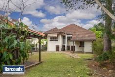  7 Uralla Street, ASHGROVE QLD 4060 Rarely does a property ooze so much potential. This original 1950's home sits on a generous 620sqm in a lovely leafy pocket. Whether it is a renovation project you are looking for or the opportunity to start from scratch this is the one.  When opportunity presents itself you must take advantage. Features: Generous master bedroom with built in robes 2 additional bedrooms  Large open plan lounge and dining room Neat & tidy kitchen Ornate cornices Leadlight french doors opening onto front porch Separate bathroom Downstairs laundry Security grills through out 