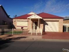  3 Second St Port Pirie West SA 5540 LOW MAINTENANCE LIVING AT IT'S BEST!!! If you are looking to down size than this property is a must see. This modern brick veneer home just oozes quality and charm. The home offers fully paved yards with imitation lawn and no gardens to worry about making it ideal maintenance free living. This lovely home presents as 2 good size bedrooms both with built-in robes and ceiling fans while the main bedroom provides a reverse cycle, refrigerated split system air-conditioner. The spacious carpeted lounge to the front features a lovely timber T.V. cabinet and feature tiles. The beautifully appointed tiled kitchen is very spacious and provides an under bench oven, gas cooktop, range hood, pantry cupboard and heaps of cupboard and bench space. The striking tiled bathroom offers a separate shower alcove, bath and separate vanity. Other features of this superb home include 9 foot ceilings, down lights throughout, tiled laundry with clothes dryer, separate toilet and a reverse cycle, refrigerated, split system air-conditioner for all year round comfort. Externally, there is a carport under the main roof with electronic rollerdoor, undercover entertaining area, external awnings and a stylish front fence. For added security there is security screen doors and windows plus roller shutters throughout and an alarm system. All in all this is a superbly presented property close to the city centre, hospital, schools and TAFE and would make a great Investment or ideally suitable to Retirees or a Professional Couple. Inspection thoroughly recommended!  