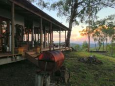  126 Bucketty Private Road No 1 Bucketty NSW 2250 Imagine almost 30 acres (11ha) within an hour and a half of Sydney CBD, where the mist drifts within the inversion layers, between the bush valley floor and the peaks of the ridgelines and away into the far horizon.  Live outside of the box with this dwelling that has grown from a bush shack into a fantastic, spacious, character filled home with endless bush valley views and a starry night sky to die for, most likely why the Koolang Observatory positioned themselves just a couple of k's away. Situated in a quiet and private location at the very end of a 1.26 km Private Road, the property offers a wonderful lifestyle to unwind and relax. The home combines Australiana bush shack features with warehouse apartment style living, and includes modern comforts.  The galley style kitchen has stainless steel dishwasher, fridge, stainless steel cabinets, 5 burner gas cook top with large electric convection oven, a stainless steel teppanyaki grill, good sized pantry, plus bar with a stainless steel full sized second fridge - an exceptionally great kitchen for those who love to cook and entertain! The large open plan living area has ample floor to ceiling windows. Plus French doors, and the expansive feature bi-fold glass doors opening up onto a massive deck, with outdoor speakers, a sunken wood-fire pit and flowing onto the breathtaking 180 degree infinite bush ridge and valley views, sunrises and sunsets, creating the perfect place to entertain large numbers of guests or just lie around soaking in the all-day sun. Creature comforts include a big slow combustion log burner, reverse-cycle air conditioning, and timbers floors and a decorative Eucalyptus tree trunk providing warmth and character. Internal wiring is installed for sound surround, in and outdoors for this main living area plus a remote control projector screen. The main King-sized sleeping area is linked in with the open plan with a generous sized walk in robe. In addition, there are two annex-styled bedrooms. Separate to the main lounge carpeted cosy dining/lounge room with a pot belly stove is a second good sized deck with a free standing fire pit for this outside dining, bbq area, again with its own unique and beautiful outlook. Bathroom contains an original large claw bath with matching original toilet and basin. Outside, a short stroll from the home, perched looking into the valley, is a Balinese style cabin sharing the vast and beautiful view. This has a deck, chiminea, bbq and outdoor Balinese style with electric instantaneous hot shower. The cabin has Foxtel, a queen sized romantic-styled bed, small fridge, air-con and heater, microwave and good storage. There is also a 3 bay carport adjoined to a lock-up fully powered tool shed, a trailer port, potting shed, wood shed and an enclosed herb garden. There is Optus mobile broadband available. Many of the furniture and furnishings will be included with the sale, including handcrafted beds, some items negotiable. This thoroughly unique and inviting home is within commuting distance of Sydney or Newcastle and around 40 minutes from Gosford, Tuggerah or Cessnock.  For further information regarding this property, or appointment to inspect, please contact Michael Kidd Property Sales Pty Ltd on (02)4376 1440. This information is obtained from various sources and cannot be guaranteed. You must make your own enquiries as to its accuracy.  Copyright Michael Kidd Property Sales Pty Ltd. Property FeaturesProperty ID10926803Bedrooms3 Three sleep areas plus cabinBathrooms1Land Size27.72 Acre approx.ShedYesdeckYesOutdoor EntYes 