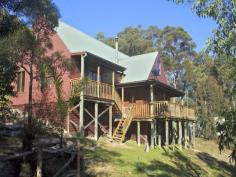  19 Private Road 3 Bucketty NSW 2250 Beautifully Crafted Timber Home on 28 Acres With stunning design and meticulous craftsmanship, this bushland retreat is as much a work of art, as a home. Flowing and generous, the home has a spiritual artistic feel and moulds into the hill side with its tri-level design. Set high on the 28 acre property (11.31Ha), the home is positioned to capture the beautiful view across bushland hills to the Bala Range. This unique home has been cleverly designed and built by the owners, and includes handcrafted cabinets and balustrades, a 21 foot high cathedral ceiling and a variety of carefully selected quality timbers including oregon, maple and 100 year old recycled timber. The master suite is luxurious, with generous size, has an ensuite with corner spa and a walk in robe. The second bedroom is also exquisitely generous and has an ensuite and opens onto the balcony. The kitchen is beautifully crafted, with solid recycled timber benchtop, handmade cabinet doors, walkin pantry, island and eat in area. The spacious formal dining room can accommodate a large table, and is ideal for entertaining. Flowing down into the lounge area with combustion fireplace and balcony with magnificent views across to the Bala Range. General Features Property Type: Acreage/Semi-Rural Bedrooms: 2 Bathrooms: 2 Land Size: 11.33ha (28.00 acres) (approx) Price per acre: $24,643 Outdoor Features Balcony Other Features Beautiful Tri-level Open Plan Timber Home with Views 