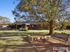  92 Thomsons Road, Armidale NSW 2350 Located an estimated 15 minute drive from town, this secluded rural retreat is situated on approximately 10.2 hectares (25.2 acres) and will appeal to those who love room to move and a private homely atmosphere. With abundant features this property includes: - 	 Five bedrooms; the Fifth bedroom could also double as a study with inbuilt bookshelf, two of the rear bedrooms feature an ensuite in each and both bedrooms allow access to the house yard - 	 Teenage or guest retreat, detached from house with bathroom, living room, dining area and additional two bedrooms - 	 Solid Timber kitchen with large square island bench, wood heating and plenty of room for the dining room or informal living area - 	 Living area at front of the home off kitchen with another wood heater - 	 Generous sized laundry and main bathroom with shower, toilet and bathtub - 	 Linen storage in the hallway - 	 Secure fencing, 2 water tanks which make up 30,000 gallons of water capacity, and a dam and creek access - 	 Salt Water above ground pool - 	 Double brick home to keep in the warmth throughout summer, and allows the house to remain cool in the summer months - 	 Solar Hot water system with electric booster - 	 Double carport with attached lockable workshop. 