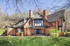 174 Oxley Dr Mittagong NSW 2575 Web ID : 	 1650065 Price : 	 $2,990,000 Property Type : 	 House Sale : 	 Private Treaty Land Size : 	 3 Acres Woodland garden estate in picture book setting 4 4 2 Redlands' is a glorious woodland garden estate featuring a regal Tudor style manor as its gracious centrepiece. Set on 1.2 hectares (3 acres) of magnificent grounds, the property enjoys an idyllic picture book setting a short drive to Bowral and Mittagong town centres. Micro-climate gardens with Paul Sorensen design trademarks Rare and exotic trees, meandering pathways, dry stone walls Previously renovated residence with scope to enhance further Grandly proportioned interiors enjoy private, leafy outlooks Formal reception areas plus spacious open plan family room Gourmet kitchen with prestige appliances and walk-in pantry Four double sized bedrooms, three with ensuite Hydronic heating, timber floors, alarm and cellar/storage Automatic double lock-up garage with direct internal access Short drive to Bowral and less than 90 minutes to Sydney. Property Features Alarm SystemBuilt-In WardrobesFireplace(s)GardenSecure ParkingPolished Timber FloorFormal LoungeSeparate DiningHydronic heating 
