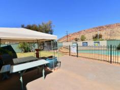  4/16 Bradshaw Drive Gillen NT 0870 With prime elevated views of Heavitree Gap as well as panoramic East and West MacDonnell Range views it will be hard to stop looking.  This two bedroom first floor unit has all the trappings of the ground floor units without a private yard. There is still plenty of common area to enjoy a social BBQ, swim in the pool or just read a book in the resort style garden setting. The entire unit has vinyl flooring and ducted evaporative air throughout. Open plan living is the theme in the lounge, dining and kitchen areas while the bathroom has a bath, shower and toilet. A real bonus with this unit is a 12m x 6m insulated shed that has had a lot of detail added to the inside. Divided into sections to accommodate a garage, a storage area and a games room/studio it is still diverse enough to cater to an individuals specific needs.  The grounds are immaculate and recent kerbing, bitumen & line marking make private off street parking a breeze.  Priced to sell to either the astute investor or happy home owner. 