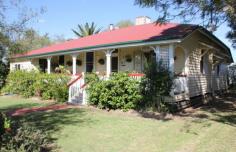  17 William St Millmerran QLD 4357 DETAILS $315,000 Residential Bedrooms: 4 Bathrooms: 2 Garage Spaces: 1 1st Time Opportunity—”The Post Office House” Available For Separate Sale – $315 000 Area: 1010 Square Metres – Renovated Queenslander with character and charm, 4 Bedroom timber home, all b/rs with ceiling fans & built-in storage, main b/r has ensuite & opens onto verandah, 2nd b/r has large w.i.r.. Large formal lounge room with fire place & ceiling fan, stylish main bathroom with shower over bath, toilet & vanity, wide hallway, wide polished original timber floorboards throughout, office, laundry with plenty of storage space, front verandah with northern aspect, single garage, under cover outdoor living area, cubby house, garden shed, established gardens, fenced yard. Only minutes to walk to the Main Street & all town amenities. Backyard access to Bowls Club 