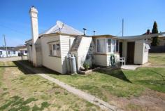  14 Railway Street Tenterfield NSW 2372 $135,000 This older style home sits on a good 1186 square metre allotment with two titles with a large workshop/shed and garage. The home comprises 3 bedrooms, enclosed front verandah, lounge with wood heater, kitchen that has been freshly painted with new floor coverings and new electric stove, bathroom with shower and separate toilet, porch and laundry. This home is an entry level option and worthy of inspection. Property Features Property ID 	 9057473 Bedrooms 	 3 Bathrooms 	 1 Garage 	 3 Kitchen 	 electric stove, new floor coverings Lounge 	 wood heater Back Yard 	 large yard with lots of sheds Inclusions 	 Curtains, insect screens, stove, light fittings, clothes line, fixed floor coverings, T.V antenna. Flooring 	 timber Under House 	 timber stumps Land Size 	 1186 Square Mtr approx. Building Age 	 40 Rates 	 1,700.00 Fully Fenced 	 Yes Shed 	 Yes Workshop 	 Yes 