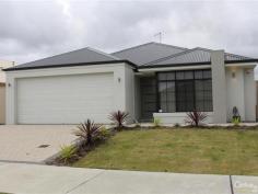  10 Buttermere Approach Waikiki WA 6169 STYLISH HOME IN HARRINGTON WATERS ESTATE WITH ALL THE EXTRAS Quality built Easy Start constructed home only 9 months old and set in the sought after Harrington Waters Estate.  This home is beautifully presented and has quality fittings and fixtures throughout plus all the extras - evaporative air-conditioning, monitored alarm system, good size minor bedrooms all with double built in robes. Master bedroom has a walk in robe and en-suite with separate toilet.  Home theatre, open plan family meals kitchen with feature 31 course ceilings, island bench to kitchen, 900mm wide oven and gas hot plate, dishwasher, double fridge recess and a dishwasher.  Great storage space to laundry and inbuilt sink with cupboard space, alfresco under main roof complete with 31 course ceiling, ceiling fan, gas point for BBQ and poured concrete flooring.  Other features include garden shed, nice low maintenance gardens with retic off mains, poured concrete with colour bond gate to side.  Property features include;  * 4 bedrooms, 2 bathrooms  * Home theatre  * Open plan Family/meals/kitchen  * Island bench to kitchen  * 900mm wide oven, GHP, R/Hood  * Dishwasher, large pantry  * Plenty of storage to laundry  * Evaporative air-conditioning  * Monitored alarm system  * Feature 31 course ceilings to family/meals/kitchen and alfresco area  * Ceiling fan and gas point to alfresco area  * Garden shed  * Double garage with auto door  * All fittings and fixtures are in excellent condition  For more details or to arrange a time to view this beautiful home please contact listing representative Niki Roberts on 0400 440 360.  