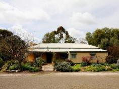  35 Kapunda St Kapunda SA 5373 $310,000 Laden with Character & Charm! Having been owned and loved for more 30 years by its current vendor this charming circa 1864 cottage is seeking a new owner to continue its heritage. Located in the beautiful town of Kapunda and surrounded by much of South Australia's farming and mining history you can't help but be enchanted by this residence upon first sight. Providing three ample sized carpeted bedrooms yet still maintaining many of the original cottage architectural features such as the flag stone floor in the kitchen, colour rich stone feature walls in the lounge, exposed beam ceilings to various rooms and some well-preserved elegant ceiling roses throughout this beautiful home. Having everything you need in a modern world yet wrapped in a vintage persona this cottage would be perfectly suited for use as a bed and breakfast holiday retreat. The kitchen has all the required amenities including a gas upright cooker, double stainless steel sink, illuminating skylight and showcases a functional original Metters wood stove. The bathroom has been updated to include a vanity, cast iron bath and separate shower with hand rail if required. This amazing cottage is nestled on a huge 5800m2 allotment and this magic home is surrounded by lush well established gardens almost botanical in nature. The attractive local bird life is a delight to watch as you relax under the rear veranda, taking in the peaceful surroundings you may even feel as though you have been transported to a beautiful English garden suitable for a picnic or high tea.  Close proximity to both the Primary and Secondary Schools and a short stroll into the main street. There is a roller door garage plus additional shedding which also includes wood shed and tool shed to lock up the garden tools. Let your heart explore this charming and romantic cottage in a perfect location that will allow another chapter in its journey of life to be unfolded and lived 