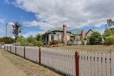  120 Arthur Hwy Dunalley TAS 7177 $249,000 Picture Perfect Classic 1870's weatherboard cottage has been renovated to compliment, retain and enhance its many charming original features. Offering 3 bedrooms this home is entered via a picture perfect picket fence, along a brick pathway, through the rose garden and onto the front veranda. A welcoming spacious hallway is presented with polished timber floorboards and access to two of the bedrooms. These double bedrooms include features such as antique light fittings, fire places, ornate cornice and ceiling roses. This is just a taste of some of the character filled surprises this unique cottage has to offer.  At the end of the entry hall the galley style Tasmanian Oak kitchen awaits with adjoining dining that flows through French doors onto a timber deck, just perfect for al fresco entertainment. Step up to a separate lounge room, one may choose the ambiance of the wood heater or the convenience of modern heating. The original Dunalley post office hosts the third bedroom but also lends itself to many uses such as a magnificent master suite, games room, study, or extend to current lounge, there really are so many options. The superb bathroom will impress most on first inspection not just on size alone it offers quality fixtures including a claw foot bath as the centerpiece, a separate shower, large vanity, ample storage and linen press. The rear of the property presents another private entertaining area, second toilet, laundry, workshop and more storage options adding even more value to this charming home. Enhanced by cottage gardens, established fruit trees, olive trees, rose bed and two single garages this warm and welcoming home reaped in history is on 2 titles totaling 1725m2, has no immediate neighbours, enjoys water glimpses over Blackman Bay and is only a short stroll to the school, shops and cafes. An absolute must on the inspection list. General Features Property Type: House Bedrooms: 3 Bathrooms: 1 