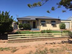  209 Lacey Street Whyalla Playford SA 5600 $255,000  Get a look at this one! Double brick home in a great elevated location – a great option for your first home!  Good size lounge with polished floors, split system air and archway into kitchen/meals  The kitchen has a breakfast bar, good cupboard space, electric stove tiled meals area  Bathroom is neat and offers shower over the bath and vanity unit  3 good size bedrooms with polished boards, Built In Robes, ceiling fans and quality drapes  (bed 1 has a large split system air conditioning unit)  Tiled laundry and toilet area finish off the interior of the home!  Check out the Entertainers paradise at the rear of this home with a fabulous all weather undercover entertaining spot, a lined rumpus/games room with floating floors and air-conditioning, workshop area rear lane access carport and auto roller door ( fits 2 cars,) Van port  Kids are catered for too with lawns, garden area. Fruit trees and great space for them to play – plus a few steps down the road is a playground –  what more could you want???  Make an appointment to view today by Calling Century 21 on 8658688  PROPERTY DETAILS $255,000  ID: 358589 Council Rates: $1,670.50 Land Area: 900 m² Zoning: Residential 