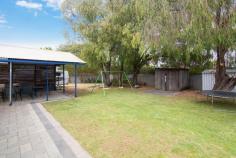  4 Hughes Cl West Busselton WA 6280 $369,000 BACKYARD AS FAR AS THE EYE CAN SEE On approx. 884m2 block sits this 3 bedroom, 1 bathroom home, 2 separate living areas, wood heater, a/c, big kitchen, gated side access, large paved gable patio, treed backyard, long work shed, designer chook house, bore. Features: Approx 884m2 block Side gated access Large paved / colourbond gabled patio Long work shed Wood shed Designer chook house Bottled gas Storage hot water Bore with new motor Large kitchen with loads of cupboard and benchspace Kitchen overlooking backyard and direct access to entertaining area A/C for summer Wood heater / log fire for Winter Gas oven Sep lounge Dining/living off kitchen Linen cupboard Executive Roll down blinds all throughout Separate wc room Within the bathroom you have sep bath in bathroom And separate shower recess with screen Mirrored vanity space Master with mirrored robe Second bedroom with walk in robe Security screened front door for summer breeze with security Undercover parking Character front verandah Outdoor electric points  Fully established garden and garden beds Good guttering Tile roof Two tone brick faade for country style 