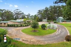  10 gibboketon Pl Wallaga Lake NSW 2546 $639,000 "Asmara" - Situated on a generous 4581 m2 block of land backing onto bushland, this single level three bedroom, two bathroom home has a lot to offer and is only a short walk to the lake and beach. Features:  Open plan design with slow combustion wood heater, large master bedroom with ensuite, two additional good sized bedrooms, bathroom, rustic kitchen and a huge sunroom at the rear.  From the sunroom, you enter a fenced area which is ideal for family pets.  The covered alfresco barbecue area is up a couple of steps and next to a single garage.  The front yard is level with nice grass areas and minimal gardens. Garages:  At the rear of the property is a 12m x 12m American Style Barn with three roller doors.  The centre door is high and ideal for boat storage.  The large single garage next to the house has plenty of workshop space and the other single garage near the barbecue area is ideal for storing items for your family gatherings. Location:  This quiet, friendly neighbourhood backs onto bushland and is within an easy walk to Haywards's Beach, Wallaga Lake and many good fishing spots.  The beach has a large section that is dog friendly.  A short drive into Bermagui and even more pristine beaches, ten minutes to Central Tilba with its many specialty shops and cheese factory. Rent Back:  The vendor is downsizing and would like to rent back for a few months or discuss renting the large shed at the rear to allow him time to move into his new property. 