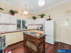  203 Whatley Crescent Bayswater WA 6053 $739,000 This lovely character home with high ceilings, Jarrah floorboards, stained glass entry way and art deco features was built in 1931, and sits on 782 sqm’s of prime real estate in the recently rezoned Meltham Station Precinct Structure Plan. The house has three large bedrooms, two with built-in robes/storage and one with a fireplace. At the end of the central hall is a shower/toilet, before leading into a large kitchen with a Belling twin-fronted electric oven with seven gas-top burners. There are reverse cycle, split air-conditioners in two bedrooms and the living room, which also has a gas spear for winter heating. The lounge-dining area is framed by French doors which open onto a stunning 36 sqm Jarrah deck protected by a pitched roof, tastefully designed in keeping with the period style of the house and fabulous for all-weather entertaining. The southern end of the living room opens into a second bath/toilet and houses the laundry facilities behind a separate door. From the deck itself you look into a magnificent garden of mature trees which have been chosen for summer shade, autumn splendour and spring blossoms. It’s a wonderfully peaceful and private space: you’d never know you were just a three minute walk to the train station (nine minute ride into town) and 5.5km’s from the CBD by car. The lawns are fully reticulated by bore, and its Davey pump was replaced in 2016. There is also a 1,260 litre rainwater tank by the side of the house for general use. There are 10 solar panels on the roof helping with power bills, as well as a high-tech Solargain hot water system installed in 2015, feeding a 315 litre storage unit with an electric boost for winter. These charming homes on big blocks close to the city are now very rare and this one won’t last long. Walking distance to shops and cafes – it’s ideal for a professional couple or young family looking for the inner city lifestyle with an old fashioned backyard, or land to extend if required, or the savvy investor who can clearly envisage the development potential in this block-o-tunity. Features – 	 782 sqm’s land in Meltham Station Precinct – 	 Three large bedrooms – 	 Two bathrooms / two toilets – 	 Jarrah floorboards – 	 36 sqm covered Jarrah deck – 	 Three split system air-cons – 	 High ceilings – 	 Antique and vintage light fittings – 	 Belling twin oven with seven gas burners – 	 Gas spear in living room – 	 1,260 litre water tank – 	 10 solar panels – 	 Solar hot water with 315 litre tank – 	 Close to shops, cafes, schools – 	 Established garden – 	 250m to train station, 5.5kms to CBD. 