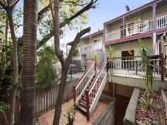  2/17 Martha Street Paddington QLD 4064 $570,000 + Ideally located in the exclusive inner suburb of Paddington, this gorgeous leafy townhouse offers a relaxed and very private city lifestyle that combines practicality and charm within a five-minute commute to the CBD. Federation-style features such as picture glass doors, verandahs and sash windows add character to the thoroughly modern and generous open plan layout, enviable entertaining deck and neutral colour palette of this impeccably-maintained home. Features include: • Expansive open plan dining and kitchen area boasting timber floors and opening onto the rear terrace deck which overlooks the landscaped backyard – ideal for relaxed entertaining with family and friends! • Separate lounge room with timber floors and room for a big screen TV • Two generously-proportioned air conditioned bedrooms, both with built in robes and balconies that offer leafy views and catch the afternoon breezes. • An upstairs bathroom with large corner bath and separate toilet • Functional modern kitchen with dishwasher and plenty of cupboard space • Terrific street appeal featuring a charming courtyard linking your own private front gate with the front verandah • High ceilings throughout & Crimsafe on all doors • Laundry in garage This expansive property boasts a total of 219m2, which includes a remote controlled 2 car (tandem) garage, and is located in a quiet boutique complex that has the benefit of low body corporate fees and onsite visitor parking. With a bus stop just around the corner providing super-easy access to the convenience of an excellent public transport network, the location is truly superb. The events and nightlife of both Suncorp Stadium and Caxton Street are within walking distance and it’s just a short, leisurely stroll to the designer shops, cafes, gym and restaurants of Paddington’s fashionable Given Terrace. Townhouses offering this much space and such a relaxed lifestyle in a prestige inner suburb don’t stay on the market for long. This is modern city living at its charming best so don’t miss your chance to inspect! Currently vacant and ready for occupancy Body Corp approx. $3,900 per annum BCC and Urban Utilities approx. $2700 per annum 