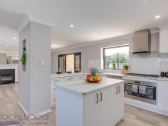  15 Wortley Road Greenmount WA 6056 $549,000 A 2018-built home surrounded by established gardens and landscaping puts you ahead of the game, ensuring you are ready to start your new life without having to bother about all of the usual ‘to-dos’ that come with a new build. This 4 bedroom, 2 bathroom Greenmount home delivers a chic, modern colour scheme, good sized bedrooms, an expansive parents’ retreat and a flexible floorplan. A below-ground pool, fully-fenced backyard and sizeable outdoor entertaining zone add the finishing touches to this stylish family home with a convenient foothills location. 4 Bedrooms 2 bathrooms 2018 rebuilt brick & iron Central open plan living Modern kitchen/meals Separate bedroom wings Spacious parents’ retreat Crisp chic colour scheme Poolside entertaining area Elevated 819 sqm block Foothills conv with views Set on the high side of the street with views of the Helena Valley this 4 bedroom, 2 bathroom home was rebuilt in 2018. A fresh, modern aesthetic, flexible floor plan and established gardens and landscaping combine to fashion a stylish home ready and waiting to begin life with a new family. A long verandah edged with lawn and garden draws you to the front door and into the open-plan kitchen/meals/family. Large picture windows make the most of the elevated position and valley outlook. A limited colour palette and easy-care finishes create a welcoming space that is both modern and practical. The kitchen features new appliances – a 900 mm oven, 5-burner hob and rangehood. Marble-look tops and white cabinetry with brass-look handles bring a cohesive style to the central island and benchtops. In the family room, a gas log fireplace creates a cosy focus while double doors open to the covered entertaining area and below ground pool – delivering seamless indoor-outdoor living. A gas bayonet and ducted evaporative cooling ensure year-round comfort. Double French doors lead from the family room to the spacious adults’ suite occupying one end of the home. A large bedroom with ample storage opens to a spacious lounge room and ensuite. Doors from the lounge area lead to the outdoor entertaining area, an arrangement that expands the indoor-outdoor living on offer. A central hallway with a timber dado leads to the 3-bedroom junior wing, family bathroom and laundry. New carpets Two of the junior rooms are fitted with mirrored built-in robes while a third has a walk-in robe, all boast new carpet. The neutral, limited colour scheme continues in the fully tiled family bathroom. The fully fenced backyard features a series of terraced lawn and garden centred around the below-ground salt pool. A gazebo and sizeable covered patio offer ample space for entertaining and relaxation. This home is turn-key ready with established gardens and landscaping, giving you the freedom to start enjoying your new home the moment you move in. Within easy reach of the local primary school, arterial road links and the outdoor adventures of the John Forrest National Park, this foothills property is ready and waiting. 