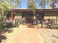  5 Noble Street Tennant Creek NT 0860 $250,000 The Territory is a great place to enjoy the great outdoors and this home has been established to capitalize on that. Located on the highly sort after Western side of town, this 4 bedroom, 2 bathroom residence is ready for new owners. Enter directly into the air conditioned, large open plan lounge/kitchen/dining area, with 2 of the bedrooms directly accessed from this area. From the kitchen a hallway runs the length of the house and gives access to the family bathroom, the 3rd bedroom, a second lounge area and the large master bedroom complete with walk in robe and ensuite. All bedrooms have air conditioning and fans and there are data points throughout the home. Outside the wrap around verandah is a perfect place to relax after work while supervising the children in the fully compliant inground swimming pool. This home set on 872m2 with rear lane access, is a reluctant sale. Currently leased for $350 per week. 