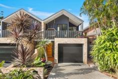  11A The Drive Stanwell Park NSW 2508 A unique statement of luxury and sophistication, this stunning, bright and modern, near new duplex combines cutting edge design with an inspired family friendly layout. With exceptional attention to detail throughout, no expense has been spared in creating a lifestyle of comfort and convenience situated in a peaceful yet convenient location in the ever popular coastal village of Stanwell Park within a leisurely stroll to local shops, schools, beach and parklands as well as transport options to both Sydney CBD and Wollongong. The well designed and light-filled floor plan features skylights,a combination of louvre windows, soaring ceilings and the finest of fixtures and finishes. Key features include high-end finishes throughout, air-conditioning, low maintenance, open-plan living which compliments the inviting indoor/outdoor areas for year-round entertaining. - Clean lines, premium finishes & fluid indoor/outdoor entertaining throughout - State-of-the-art kitchen with stone benchtops, ample storage and high quality Appliances - Spacious master suite with private balcony, chic ensuite and walk in robe - Additional two bedrooms are generous in size and both feature BIR's and balconies - Auto garaging with internal access as well as carport accessed from the rear lane - Private entertaining deck and outdoor shower - Spacious internal laundry with second toilet on the lower level There is nothing to do, just move straight in and start enjoying the relaxed coastal lifestyle. ** Whilst every effort has been made to ensure the accuracy and thoroughness of the information provided to you in our marketing material, we cannot guarantee the accuracy of the information provided by our vendors, and as such, Ray White Helensburgh makes no statement, representation or warranty, and assumes no legal liability in relation to the accuracy of the information provided. Interested parties should conduct their own due diligence in relation to each property they are considering purchasing. All photographs, maps and images are representative only, for marketing purposes. FEATURES: • 	 Air Conditioning • 	 Built-In Wardrobes • 	 Dishwasher • 	 Secure Parking • 	 Study Nook • 	 Terrace/Balcony.. 