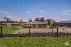  162 Pasley Street Huntly VIC 3551 $890,000 - $979,000 Sitting on over 4,000 square metres, this 5 bedroom home boasts fantastic size not only in the block but in the house itself. With 3 living spaces plus a parents retreat, and a dedicated home office, as well as 3 bathrooms. This fabulous Todd Newman build offers grand hallways and high ceilings throughout. Opening up into a large open plan living, dining and a kitchen area. The entertainers' kitchen boasts 900mm wide gas appliances, a large walk-in pantry, great amounts of storage and a breakfast bar. This space leads out to a large undercover alfresco area. The master bedroom offers a walk-in robe, ensuite bathroom with twin vanity and a separate parents' retreat. All remaining bedrooms are a great size and offer built-in robes. The home is kept comfortable with ducted heating and cooling throughout and also has the convenience of a double lock-up garage with direct internal access. The home also offers fantastic shedding and carport, plenty of room for all the toys! Huntly has seen fantastic growth, with great infrastructure and amenities.  