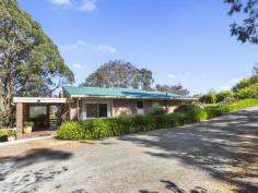  24 Holborn Hill Road ALDGATE SA 5154 Graced by a glorious front garden with circular driveway you are met with the serenity of Hills lifestyle. Set on 1 acre (approx.) of an abundance of fruit trees, gorgeous protea trees, well maintained garden and native outlook from the back deck. Built in 1978 this spilt level three bedroom home greets you with an abundance of natural light and raked ceilings. Year round comfort is provided with the combustion heater and reverse cycle air-conditioner to the living room and formal dining. Adjacent is the near new well-appointed kitchen which is equipped with two Electrolux wall ovens, induction cooktop and dishwasher and another reverse cycle air-conditioner. The family dining room opens out to the deck with glorious native views and the resident koala may pop by to say hello. The main bedroom situated at the front of the home is of a generous size with a walk through robe to the ensuite bathroom. Bedrooms two and three both with ceiling fans and mirrored robes enjoy a beautiful outlook to the front gardens. The office / bedroom 4 has its own separate entrance if you wish to work from home. The retro red bathroom is an eye catcher flooded with natural light, separate shower and bath. Separate toilet & laundry. For the Adelaide Hills wine lover there is an underground cellar to store all your precious collections. The property is fully irrigated, with the grounds including a large shade house, garden shed, small chicken shed & vegetable garden. To the side of the driveway sits a large 2.5 bay garage / workshop and carport which is equipped with power, alongside is a fire pump connected to a rainwater tank, necessary for Hills living. A 20,000 gallon rain water tank services the house (this can be switched to mains water). This rare find in the Adelaide Hills is situated on a peaceful no through road only minutes to Aldgate Pump Hotel, Aldgate Village, Aldgate Primary School and transport to city. Features include : • Generous sized main bedroom with walk through robe & ensuite • Two additional bedrooms with ceiling fans & robes • Office / Study with separate entrance • Abundance of natural light throughout home • Light & bright kitchen with near new appliances • Family bathroom with bath & shower • Combustion heating & reverse cycle heating / cooling • Ceiling fans throughout to circulate airflow • Gorgeous grounds of 1 Acre (approx.) • Elevated native fauna & flora outlook • Underground cellar for the wine enthusiast • 20,000 gallon rainwater tank • 2.5 bay garage / shed with carport • Circular driveway with ample parking 