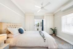  2/20 Wolseley St Drummoyne NSW 2047 Peaceful and welcoming, this elegant two-bedroom apartment in a refined Art Deco building blends classic style with light-filled living spaces and an easy-care layout. Conveniently located on the ground floor, which enjoys direct access to a leafy courtyard, while its elevated position delivers district views. Beautifully presented heritage features, such as high ceilings, picture rails and timber floors, are complemented by thoughtful modern upgrades, including air conditioning and carpeting in bedrooms. In addition to the spacious guest bedroom is a king-sized master featuring built-in robe and adjoining sunroom with a bright north-east outlook. Ideally situated for easy access to the CBD and bayside recreation, only 350m to ferry and bus routes, 600m to Five Dock Bay Esplanade. • Charming two-bedroom apartment in a quiet, east Drummoyne complex • Sunlit lounge featuring tiled fireplace, wide windows, and district views • Full-sized gas kitchen with plenty of storage, subway tiling, and Bosch dishwasher • Modern bathroom featuring designer vanity and combined shower/bath • Expansive master with dual built-in robe, air con and ceiling fan • Large sunroom with potential use as home office, art studio, or study • Double guest room including built-in robe, air con and ceiling fan • Internal laundry offers room for washer, dryer, and storage • Single space lock-up garage with additional storage space 