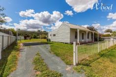  24 Day St Henty NSW 2658 $235,000 Tidy two bedroom home set on a huge 1012sqm block with rear lane access, and opportunity to develop further. The miner's cottage styled home features the traditional central hallway, Murray pine timber flooring, which opens up to a large open kitchen meals & family room. This also extends to a covered outdoor alfresco, entertainment space to enjoy that large block. The kitchen has been tastefully updated and includes an enormous amount of preparation benches, cupboards, an electric cooktop and under bench oven. The open planned living room offers a wood fire and a reverse cycle split system air conditioner. The 2 generous sized bedrooms are service by a bathroom and then there is a separate laundry & toilet. With front and rear access, the property includes a double carport and as mentioned, a block plenty large enough for a second dwelling, or any amount of shedding if required. Centrally located within the township, you can walk down the road and have a swim at the local pool, there's plenty of shopping facilities and I hardly miss the opportunity to call in to the local bakery for a coffee & where you can enjoy some beautiful treats or a wonderful lunch. 