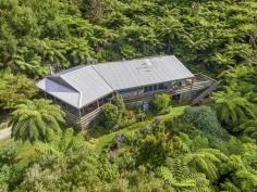  340 Mount Best Tin Mine Rd Toora VIC 3962 $795,000 Surround yourself with nature and enjoy total privacy and seclusion on approx. 7.58 stunning acres of lush rainforest. A truly unique sheltered pocket of paradise teeming with birds and wildlife. Long all-weather driveway leads you to a world of your own with towering tree ferns, pockets of colourful gardens, orchard and places to sit and enjoy the tranquility. A wide deck welcome you into the home with views out to the surrounding countryside and distant coast. Soaring cathedral ceilings with huge beams create a wonderful feeling of space with an expansive living room, modern central kitchen and adjoining dining area, all flowing out onto the deck making this an entertainer's delight. Comfortable in every season with a wood heater plus the convenience of a RC/AC. There are three bedrooms, central bathroom and laundry / utility space. Practical features include satellite TV and NBN, abundant water storage, solar power system plus mains, solar hot water, flat parking for multiple cars, LU garage / workshop with lights, power and concrete floor, carport / boat / van storage, guests parking area. Just 15 minutes from town, school bus passing and 5 mins from the welcoming Mount Best hall and community hub. If you are seeking something extraordinary then this is a must see. 