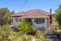  57 Frederic St Midland WA 6056 $399,000 Dream big as you work your magic to transform this 1950s California bungalow into an impressive character home. A wide frontage, elevated situation and original features mark the path toward returning this 3-bedroom, 1-bathroom home to its former glory. An enviable location, steps from Blackadder Creek and La Salle College and minutes from the banks of the Swan River, the home boasts views of the distant Hills, a fully fenced backyard, a brick workshop and a single garage. 3 bedrooms 1 bathroom 1950s Hardi w’board tile Leadlight windows doors High ceilings orig fireplace Large family-style kitchen Powered brick workshop Separate laundry 2nd WC Garage fully fenced b’yard 1120 sqm 30 m frontage Elevated with Hills views There is work to be done, but the rewards could be enormous. With characteristic features, including sturdy tapered pillars, high ceilings and leadlight doors and windows, you will find a sense of nostalgia and inspiration at every turn. A classic front porch with views out to distant hills, a generously proportioned lounge and era-defining leadlight doors and a built-in verandah/sleepout offer ample authentic character and leave no doubt about this property’s origins. High ceilings, original window frames and leadlight, and a kitchen/family room with an ornate ceiling rose and cornices suggest a thoroughly modern future. The main bedroom sits at the front of the plan, a window looking out across the broad front yard. Three junior bedrooms give you a choice when adapting the existing floor plan. The sleepout could be styled as a fabulous sunroom or study looking out to the backyard. In the fully fenced backyard, a partitioned brick workshop, garage and a separate laundry with WC sit amongst vintage rose bushes, grape vines and garden beds waiting to be planted with vegetables. A sheltered, paved area between the home and laundry provides an ideal outdoor entertaining space. Sold on an ‘as is’ basis, the home’s interiors are little changed since built, with 1950s cabinetry in the kitchen and the original tub in the bathroom. The formal lounge features a decorative brick fireplace that could be recommissioned to create an impressive centrepiece. The prize for hard work, vision and perseverance could be an exceptional home with a desirable location. Frederic Street has the air of a hidden gem with its potential just beginning to peak through the surface. Those with an eye for style, heritage and convenience are taking advantage of a great location and a neighbourhood of authentic character homes. Metres from the La Salle College Campus and an easy walk from Ray Marshall Park and the Swan River, the services and amenities of Midland are minutes away, and so too are road and rail links to the CBD and beyond. Don’t miss the opportunity to create an exceptional home in an incredibly central location. Whether you accept the challenge and transform this California bungalow into a modern home or begin again taking advantage of the wide 1120 sqm block (STA), this could be the property or your dreams. 