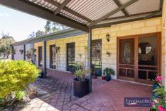  7000 Bunning Rd Gidgegannup WA 6083 $1,350,000 An executive home, striking alfresco entertaining zone, a below-ground pool, reticulated paddocks, and 2021-built ancillary accommodation is multi-generational living at its best. Surrounded by 5.41-acres of pastures with majestic ghost gums, reticulated gardens and a powered workshop, this prestigious property is an idyllic setting to raise a family, keep animals and embrace the Hills lifestyle. 4 bedrooms 2 bathrooms 2001-built brick and iron Executive family home 2021-built 3 x 1 ancillary Solid jarrah floorboards Huge alfresco living zone Below-ground salt pool 5 Reticulated paddocks Large Powered workshop 5.41 acs, bore, 120-K tank A gum-line driveway carries you through an automatic gate to the welcoming verandah of this impressive, multi-generational property. Views across a green lawn to paddocks greet you at the front door. As you step inside, a spacious foyer with high ceilings and gleaming jarrah floors opens to two large living areas. To the right is an expanse of informal, open-plan living with a kitchen and family room leading to an outdoor entertaining zone by which all others should be judged. Reverse cycle air-conditioning and a slow combustion fireplace fashion a room with year-round appeal with three large windows framing everchanging views across paddocks. This relaxed communal space flows into a granite kitchen with timber cabinets, a large walk-in pantry and a sweeping expanse of benchtop with an integrated breakfast bar. If a 900 mm oven with a 5-burner gas hob, an integrated microwave and a dishwasher set your culinary imagination running, wait until you see the scale and amenity of the outdoor living and entertaining zone. A show-stopping space wrapped on three sides with windows, lined and fitted with a slow combustion fire, a pizza oven and an ‘outdoor kitchen’. A built-in Gasmate barbecue, dishwasher and sink surrounded by stone benchtops and metal-fronted cabinets deliver an incomparable alfresco cooking experience. Regular pizza nights, impromptu get-togethers, and unforgettable family celebrations are made more special by this purpose-built entertaining area with a door to the walled, below-ground pool. Adult and junior bedroom wings are separated by the central living zone, with the principal bedroom adjoining a formal lounge and dining room, an arrangement that lends itself to styling as a private and indulgent parents’ retreat. The main bedroom is generously-proportioned with a deep walk-in wardrobe and a spacious ensuite with a walk-in shower. The junior wing comprises three good-sized bedrooms arranged along a central hall that ends in a large multi-purpose space with French doors leading to the pool. Currently utilised as a home gym, this flexible room is an ideal playroom for young children, a fantastic teens’ retreat, and with a smaller anteroom, it provides a secluded space for uninterrupted work or study. The desire to share a property with so much to offer is only natural, and thanks to a three-bedroom 1-bathroom home built in 2021, you can. The ‘still new’ home is situated towards the rear of the lot. It uses a light-filled, neutral interior, open-plan living and a bright modern kitchen to fashion an excellent ‘granny flat’, modern accommodation for a ‘boomerang’ child, or exceptional guest accommodation. To one side of the secondary accommodation is a large, powered workshop with a 2-car carport and concrete hardstand. A Carport under the main roof of the principal residence provides additional vehicle storage. It’s rare to find a multi-generation property that so skilfully blends independent living with spaces designed for communal living. With a 5.41-acre block, paddocks to keep animals, bore-fed reticulated gardens, and solar panels, the home is move-in ready for all the family. 