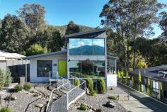  28 Fiddleback Drive Tawonga South VIC 3698 $1,500,000 - $1,600,000 Positioned in a picturesque Victorian High-Country valley is this extraordinary and ultra-modern home offering extensive unimpeded views of Mount Bogong and the Upper Kiewa Valley. This industrial themed and architecturally designed home features three bedrooms and two bathrooms with high end finishes, privacy, and elegance. Containing all the practicalities of modern living this property is set to impress and accommodate the demands of a wide range of purchasers. The breathtaking use of natural elements combine in a low maintenance front garden where slate stone flows featuring a dry creek bed with a modern fountain and gabion pillars which can be illuminated at night. An innovative above ground steel walkway reminiscent of a ski resort brings you to the remarkable entrance with a grand front door that welcomes you to this masterpiece of contemporary design unrivalled in scale, level of finish and sheer quality, this spectacular residence is unforgettable. This warm, luxurious tri-level home features extensive open plan living and is a banquet of bespoke design and detail with an industrial atmosphere comprising a lounge, kitchen, dining area and mezzanine above, all with stunning views of the surrounding countryside. The kitchen features top of the line appliances including an induction cook top on the large triangular island bench which has attached a glass breakfast bar. There is ample storage space in the kitchen with walk-in pantry, making it the perfect place for cooking and entertainment. The delightful adjacent dining area has an abundance of natural light from floor to ceiling tinted windows but transforms into an intimate and cosy dining area at night. Additional to the classic living areas there is a spacious upstairs mezzanine utilised as a sitting room offering spectacular unobstructed 180-degree views, day and night, of the Kiewa valley, Mount Bogong and the nearby township of Mount Beauty. A wonderful spot to sit and read a book or simply relax and drink in the view. Designed for grand scale alfresco entertaining the pool pavilion houses a heated 5-person spa, heated swim-jet pool with covers and a TV, perfect for all weather entertaining and being completely protected from the elements. The covered alfresco has an inside and outside counter connected to the kitchen by a bi-fold window to allow a seamless transition from indoor to outdoor living. It is an area that truly inspires and provides year-round poolside entertaining and an unparalleled lifestyle. The master bedroom is at the rear of the house and continues with the industrial and contemporary theme. Featuring a full room width, double access walk-in robe, an adjoining ensuite bathroom and large floor to ceiling windows looking out from the bedroom and ensuite over the large trees surrounding a flowing creek on the acreage behind the house. The subsequent two bedrooms are also substantial in size and have full width built-in robes. The third bedroom at the front of the house features large floor to ceiling window with spectacular views of the mountains. It is presently set up as a fully functional office/study but could be utilised as a bedroom if desired. The lowest level of the property is the most intricate containing a large workshop, garaging for 3 cars, a pool utility room containing washroom facilities and a room used as a garden shed with a separate entrance, all with concrete flooring and extensive built in cabinetry for storage facilities. Adjacent to the rear garage entrances is a large bituminous yard with ample space for a caravan, motor home or boat. The elegant gardens are low-maintenance with compact fruit trees and are auto drip irrigated for convenience. Additional features include, but are not limited to: • 	 Double glazed windows throughout with large windows being lightly tinted with heat reduction and privacy film. • 	 Instant hot water tap to a kitchen sink • 	 Insinkerator in one kitchen sink • 	 Professional reach and pull-out kitchen mixer tap • 	 Extensive LED lights throughout • 	 30 solar panels with Tesla lithium battery backup • 	 Home security alarm with outside video security cameras • 	 Comprehensive audio-visual system with speakers and TV outlets throughout • 	 2x 6000litre rainwater tanks with submersible pump supplying water to toilets, laundry and some garden taps • 	 Solar hot water service • 	 Remote controlled automatic sliding gate to driveway entrance • 	 Front bitumen driveway has additional off-street parking space • 	 Garden shed under side of house • 	 Large unused areas under floor of living area with potential for additional usable spaces for rooms or storage • 	 Secure quality fencing for privacy The residence is situated on a small new estate with modern all underground services. The estate is 3km from Mount Beauty and is set in the middle of farmland and small acreages and is a mere 45 min drive from the snow at Falls Creek Ski Resort. The rural township of Tawonga is situated in the Kiewa Valley, North East Victoria in the Heart of the High Country. Tawonga is renowned for its majestic landscape and is central to a variety of recreational activities including fly fishing, horse riding, camping, water sports, downhill and cross-country skiing, snowboarding, golf, tennis, and mountain biking, bush walking, gliding, private aviation or simply absorbing nature. The region also boasts award winning restaurants and vineyards. The exterior of this property presents unique quality architecture, while the memorable interior spaces show an incomparable combination of sophistication, cutting edge design, and spectacular attention to details. 