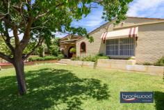  30 Bladon Way Swan View WA 6056 $625,000 An elevated position, impeccable gardens and grounds, a brand-new, never-been-used kitchen, multiple living zones and an outdoor entertaining area with a pizza oven overlooking a below-ground pool are only the beginning of this family-focussed home’s many features. 3 beds 1 bath 2 WC 1974 brick and tile Extended & reno’ed Multiple living areas Never used kitchen Pizza oven OD kitch B/G Pool, Heated Spa Carport paved drive 971 sqm elevated lot Great location Sitting proudly at the top of a paved driveway, this tastefully renovated home welcomes you with a wide front porch overlooking impeccably maintained gardens. A small formal entry opens through an archway to a media and activity room. A high ceiling with exposed beams, timber-look floors, RC AC, and a large north-facing window make this an inviting, light-filled room ideal for entertaining. The adjoining alcove, which leads into the kitchen, is an excellent activity/playroom where children can entertain themselves within eye- and ear-shot of the kitchen and central living zone. White cabinets contrast with the matt black handles, taps and sink in the never-been-used kitchen. A timber-look benchtop sweeps around a new electric hob and oven, backed by a white tiled splashback. A large extension adjoining the kitchen has created a second living area currently styled as a family/meals area. Glazing on three sides and access to a small north-facing courtyard and the expansive outdoor living and entertaining zone ensure this ample, multi-purpose space is at the heart of family life. The outdoor living zone is a showstopper with a large dining area set under a high gable roof, a sunken lounge area and a built-in kitchen with a pizza oven, all orientated to overlook the below-ground salt pool and lush back lawn. A tall leafy lemon tree shades a paved patio, a cute timber cubby sits to one side of the yard, and a powered shed and chicken coop sit towards the rear boundary in this impeccably presented, quintessential backyard. A central hall leads to three bedrooms, two of which are carpeted. The principal bedroom has a robe, ceiling fan and a resort-like outlook onto the palm-edged spa at one end of the alfresco entertaining zone. The bedrooms share the beautifully renovated bathroom with its freestanding tub, vanity, rainhead shower and WC. The walk-through laundry and a separate WC complete the layout of the bedroom wing. This stunning family home is situated in an elevated position with beautiful views to the north. It is conveniently located within walking distance of public transport and just minutes away from local shops and the services and amenities in Midland. The impressive property spacious and airy interiors provide ample space for your family to play while offering an unbeatable venue for entertaining and celebrating special moments. 