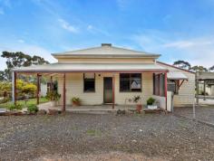  1252 Goldney Road Avon SA 5501 Nestled in the picturesque town of Avon, this charming historical 3-bedroom cottage is a rare find, offering a tranquil country lifestyle on a sprawling 4000m² block. As you step inside, you are welcomed by a cosy lounge room featuring soaring 3.5-meter ceilings, a gas heater, and a ceiling fan, creating a warm and inviting atmosphere. The main bedroom, conveniently located off the lounge, is equipped with built-in robes, a ceiling fan, and a split system for year-round comfort. The second bedroom, also accessible from the lounge, includes an air conditioning unit, ensuring a comfortable living space. The bathroom is well-appointed with a single vanity, shower, and bath, providing all the essentials for modern living. The heart of the home, the kitchen, boasts a freestanding electric oven and stove top, ample cupboard space, and a convenient servery to the dining room, perfect for family meals and entertaining. Additional features include a laundry, utility rooms, and a separate toilet for added convenience. Outside, the property continues to impress with an undercover entertaining area, ideal for hosting gatherings, and a delightful children's cubby house. A unique highlight of this property is the original 1963 brick schoolhouse, complete with its original pine flooring, an open fireplace, and a bar. This versatile space offers endless possibilities as a games room, rumpus room, or additional storage. The property also features multiple sheds, aviaries, a chook run, dual driveways, and solar power, making it a practical and sustainable choice for those seeking a peaceful rural retreat. Experience the charm and serenity of country living in this one-of-a-kind historical cottage in Avon. 