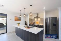 38 Mogumber Ave Midvale WA 6056 $849,000 Imagine weekend mornings where the coffee brews as you plan whether to explore the Perth Hills, head to the Swan Valley for lunch, or enjoy your private backyard oasis with friends and family. This 2022-built home in Midvale delivers the rare combination of as-new quality, contemporary design and a location that connects you to everything that makes Perth living special – without the wait, the worry or the builder’s delays. 4 bedrooms, 2 bathrooms 2022-built brick and iron Modern neutral palette Central open plan design Impressive outdoor living Zoned reverse cycle AC 32-course remote entry garage Solar panels 6.5 kW array 450sqm lot fully fenced Cool, close, contemporary Step through the front door and you’ll notice the quality immediately – large-format tiles in soft, warm tones flow underfoot, setting a calming mood that carries through the shared living spaces. The colour palette leans into muted greys and charcoal, creating a contemporary canvas that works with your furniture, your style, your life. The heart of this home is its light-filled, open-plan living area, where the family room, dining space, and kitchen merge in an expansive, effortless flow. Dual-aspect windows pull natural light deep into the plan, creating an airy atmosphere. There is enough room here for a generous modular sofa, a dining table that seats eight, and space left over for the kids to spread out with homework or play. The kitchen is equipped to meet the practical demands of family life, with a stone-topped island bench, a five-burner gas cooktop, an electric oven, and a dishwasher. A double sink signals attention to detail with its on-trend aesthetic, and modern pendant lights hang above the island, casting a warm glow for evening meals. The integrated breakfast bar becomes the morning gathering point, and a large cavity can accommodate a plumbed fridge – one less thing to organise when you move in. Privacy matters, and the principal bedroom delivers it by sitting at the front of the plan, separated from the family zones. The walk-in robe provides ample storage, and the ensuite – complete with a modern soaking tub – elevates the everyday routine into something restorative. After a long day, that tub becomes your best friend. The three junior bedrooms are a good size. 2x feature built-in robes and plush carpet underfoot. They share a well-appointed family bathroom that’s built to withstand the morning rush. A second living area creates flexibility for how you use the home – a media room, a playroom, a quiet reading space – and opens to the covered alfresco area. This is where summer evenings happen, where the barbecue gets fired up, where friends linger over drinks as the Perth sky shifts through sunset colours. The backyard strikes a perfect balance – the 450-square-metre block gives you space without the burden of endless maintenance. There’s a level lawn for children and pets, and enough room to garden if that’s your thing. A garden shed handles the practical storage, and the full fencing provides security and privacy. The remote-entry garage deserves special mention – built to 32 courses, it’s high enough for a raised four-wheel drive with a roof rack, and a rear roller door opens to a paved apron. This setup is gold if you own a boat, camper or trailer, providing secure storage that doesn’t compromise your street appeal. A 6.5-kilowatt solar array takes the sting out of electricity bills. Zoned reverse-cycle air conditioning means you’re not cooling or heating empty rooms. Blackout blinds in the bedrooms ensure sleep-ins when you need them. Low-maintenance landscaping at the front means less weekend gardening and more weekend living. Located in Midvale, you’re positioned between Perth’s eastern advantages. Midland’s city centre and train station sit roughly five minutes away by car, connecting you to the Perth CBD in under 30 minutes by train or around 25 minutes by car. Perth Airport is a 15-minute drive. Local schools, shops, and services cluster nearby, providing daily essentials. The Perth Hills unfold to the east – Mundaring, Kalamunda and John Forrest National Park within easy reach for weekend escapes. Head north and discover the Swan Valley’s wineries, breweries, and producers within 20 minutes. This home suits buyers who want to skip the construction chaos and move straight into contemporary comfort. Families will appreciate the space and layout. Professionals will value the location’s connectivity. Anyone tired of renovation projects will love that everything’s been decided, installed and finished. You simply bring your belongings and start living.